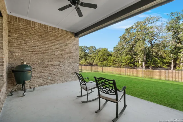 a view of a porch with furniture and a yard
