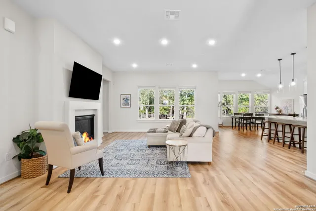 a living room with fireplace furniture and a flat screen tv