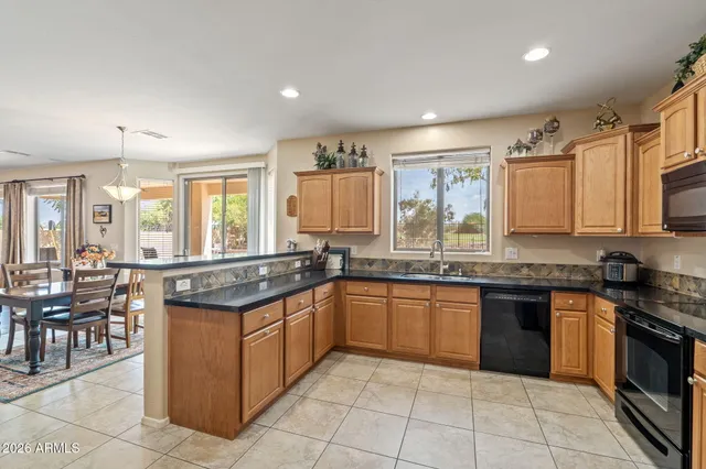 a view of a house with backyard and a tree