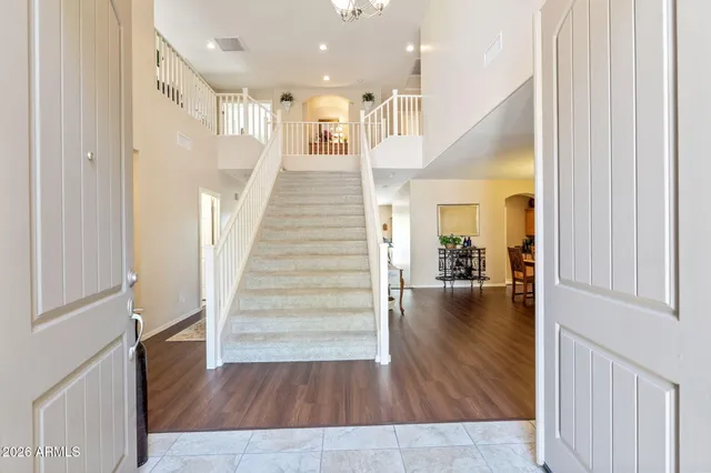 a living room with furniture a chandelier and a dining room