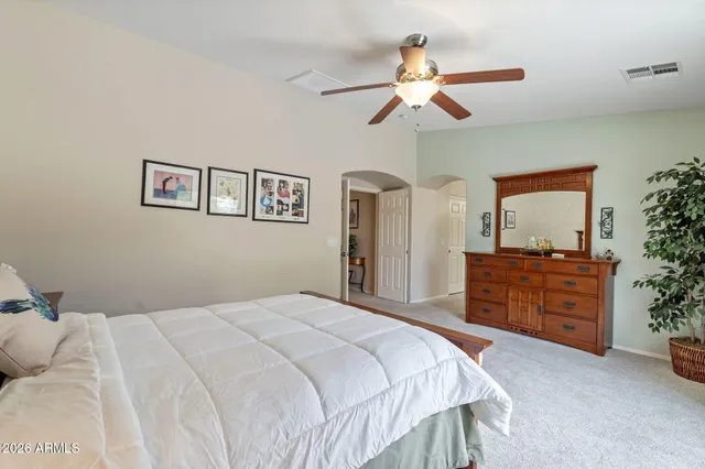 a spacious bathroom with a granite countertop sink a mirror a shower and a bathtub