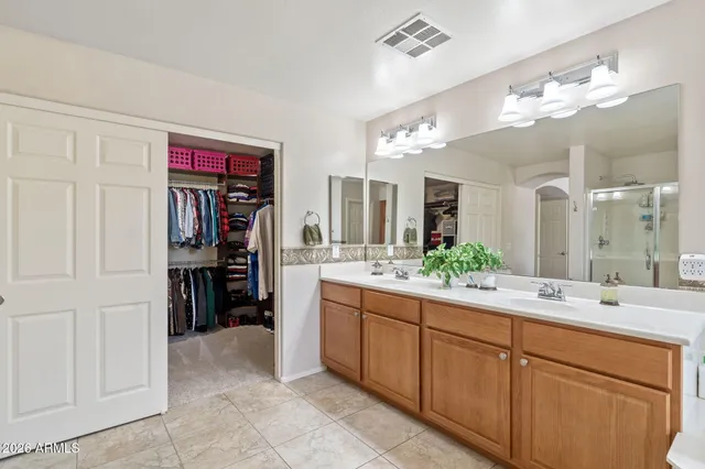 a bedroom with a bed wooden floor and window