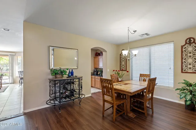 a living room with stainless steel appliances furniture and a kitchen view