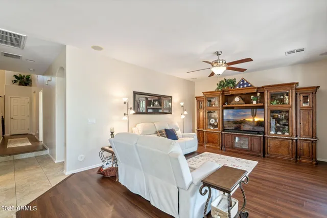 a living room with furniture a window and a flat screen tv