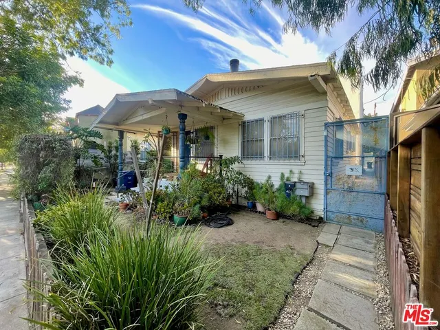 a view of a patio with table and chairs under an umbrella