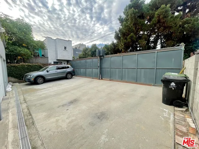 a view of backyard with barbeque grill and seating space