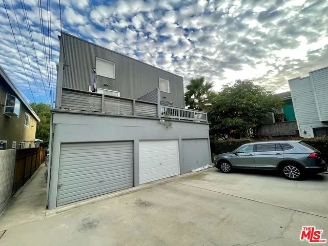 a view of garage with a car parked in it