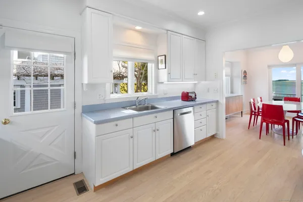 a kitchen that has a lot of cabinets in it and appliances