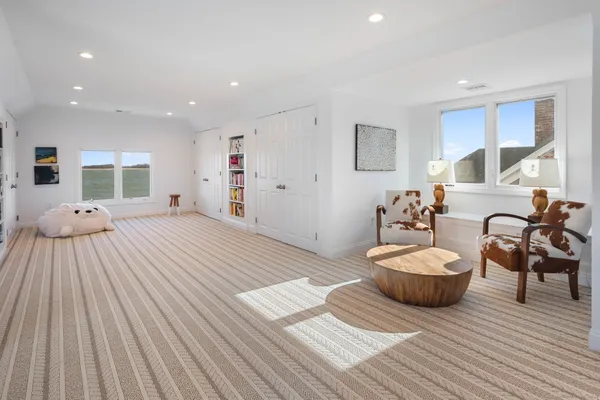 a bedroom with furniture and a wooden floor