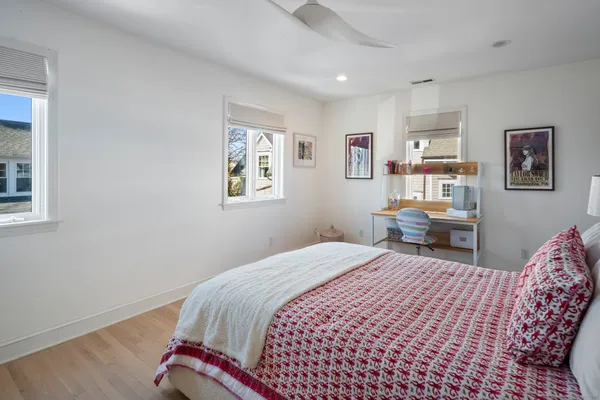 a bedroom with a bed and a wall painting
