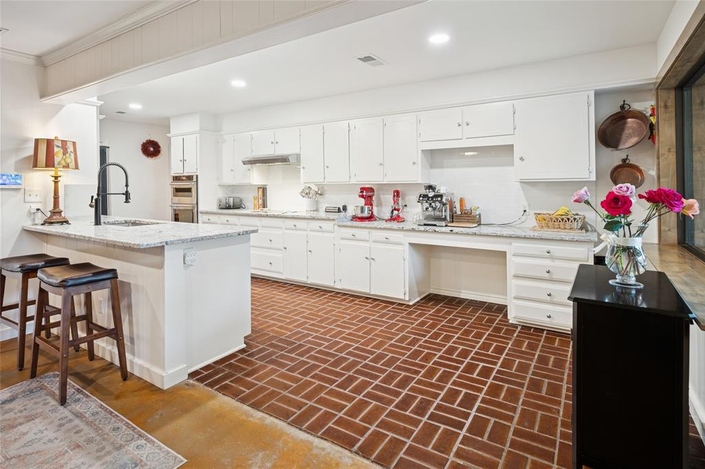 3701 Streamwood Road Fort Worth, TX 76116 - Photo 11 of 34 a kitchen with a sink stove and white cabinets