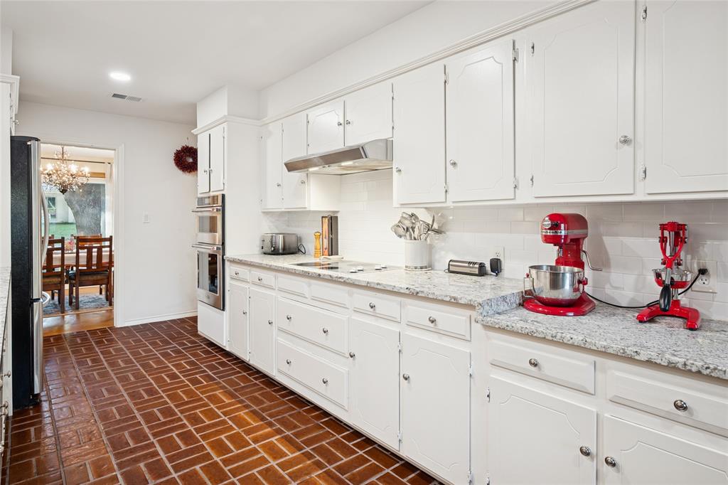3701 Streamwood Road Fort Worth, TX 76116 - Photo 12 of 34 a kitchen with granite countertop white cabinets and sink