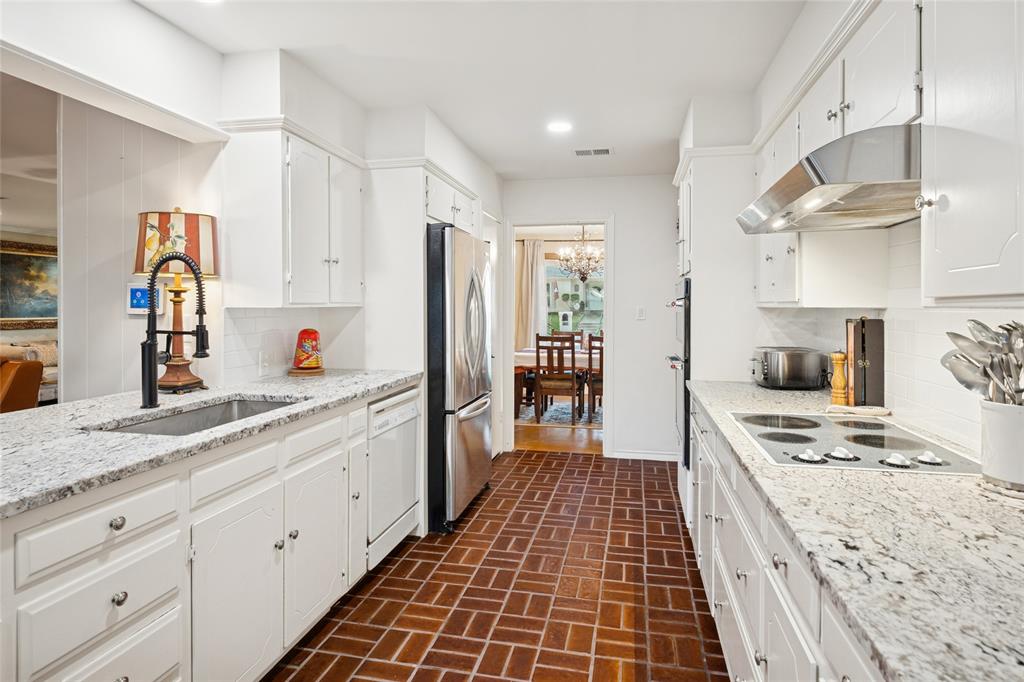 3701 Streamwood Road Fort Worth, TX 76116 - Photo 15 of 34 a kitchen with stainless steel appliances granite countertop a sink stove and refrigerator