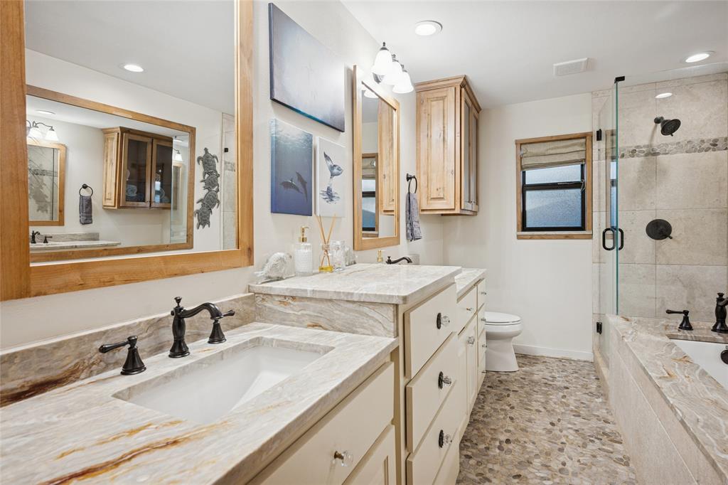 3701 Streamwood Road Fort Worth, TX 76116 - Photo 21 of 34 a spacious bathroom with a granite countertop sink mirror and a