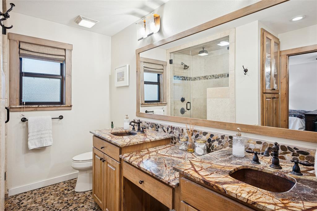 3701 Streamwood Road Fort Worth, TX 76116 - Photo 26 of 34 a bathroom with a granite countertop sink a toilet and a mirror