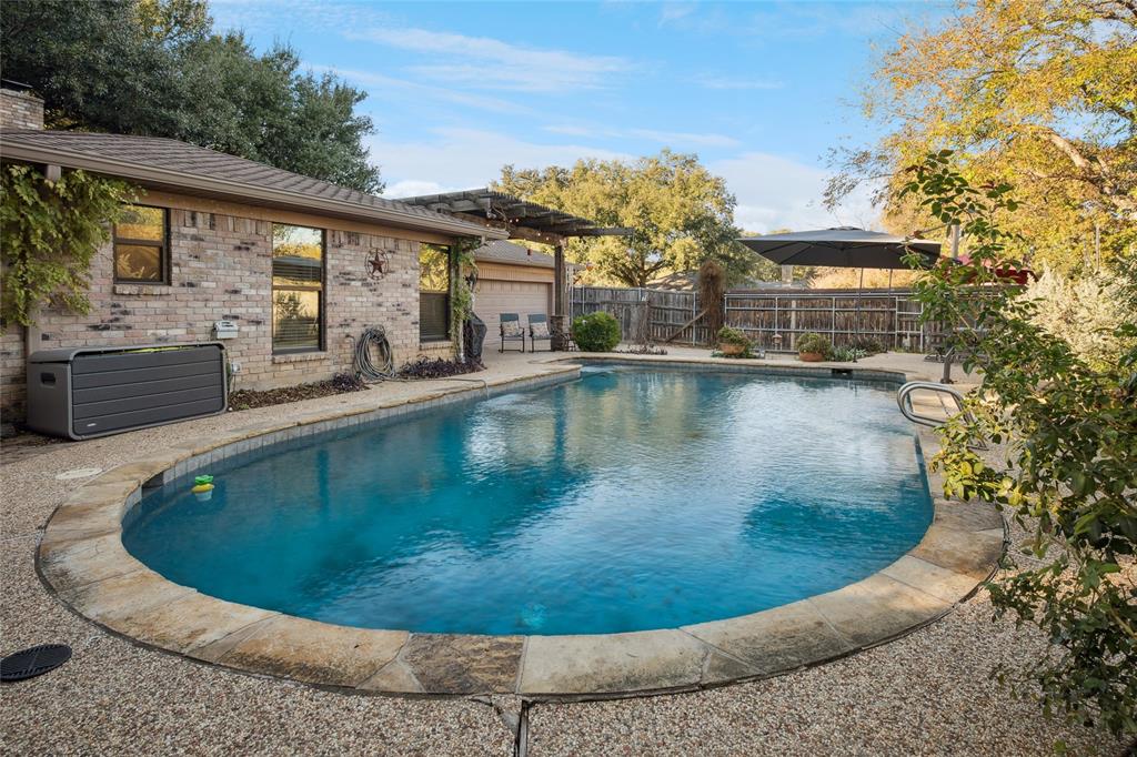 3701 Streamwood Road Fort Worth, TX 76116 - Photo 31 of 34 a view of a swimming pool with a patio