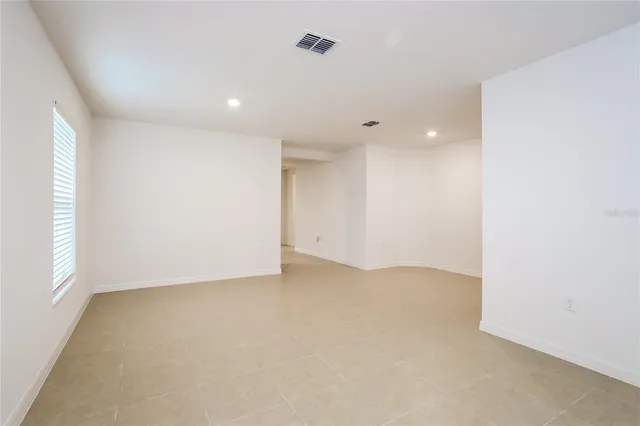 an empty room with a empty space and windows