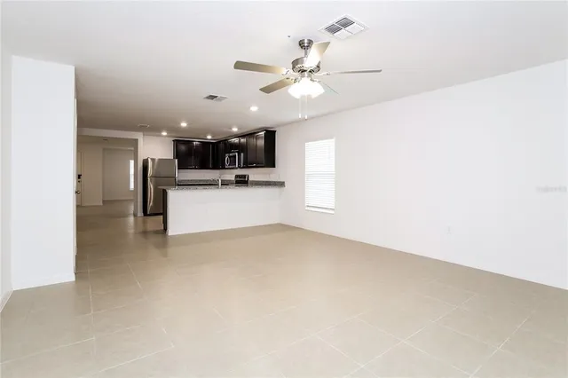 a view of a kitchen with a sink and a refrigerator