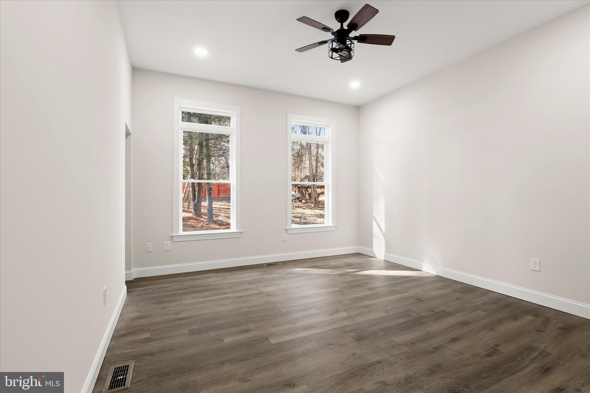 5004 Ten Oaks Road Dayton, MD 21036 - Photo 46 of 99 a view of an empty room with a window and wooden floor