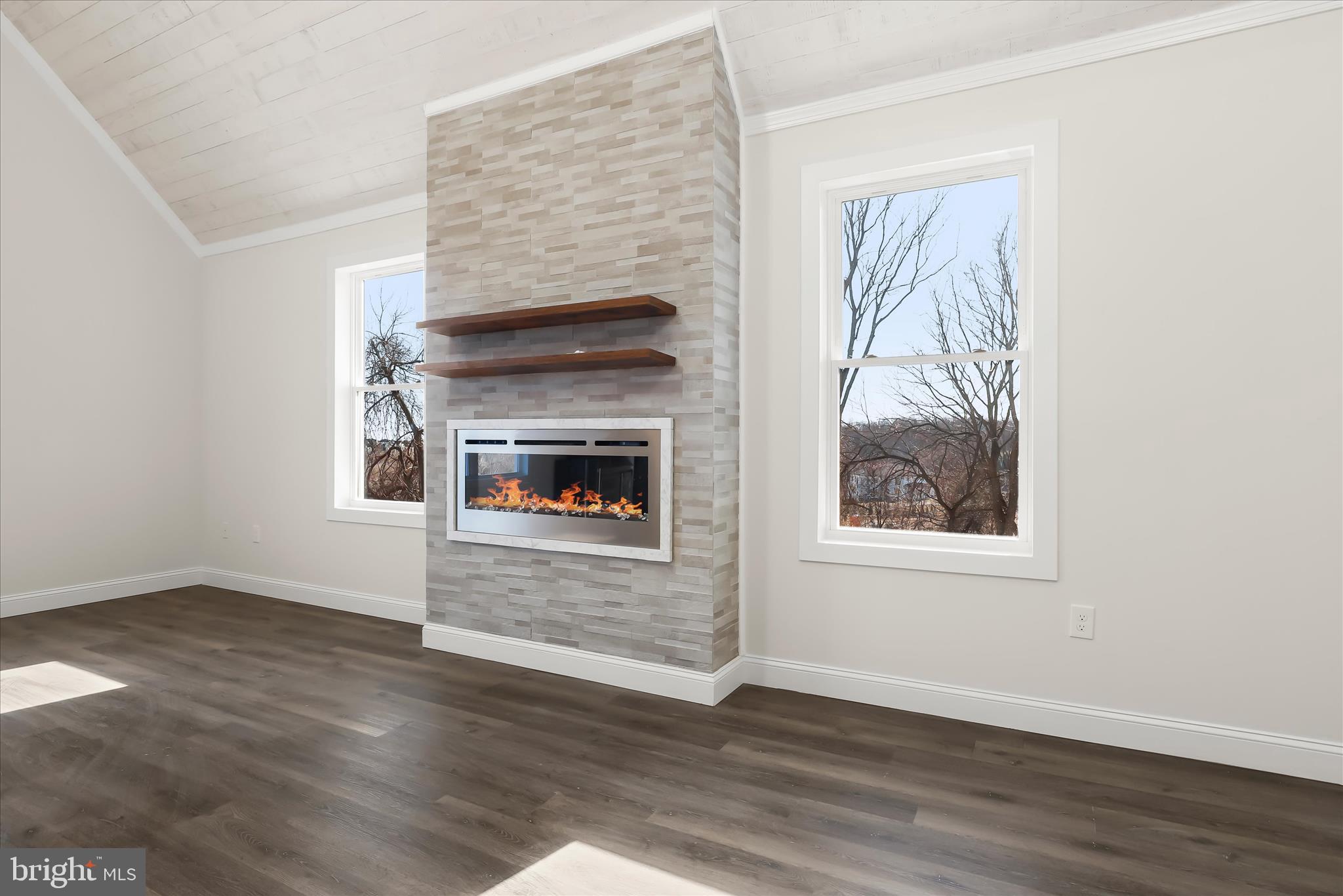 5004 Ten Oaks Road Dayton, MD 21036 - Photo 54 of 99 an empty room with wooden floor a fireplace and windows