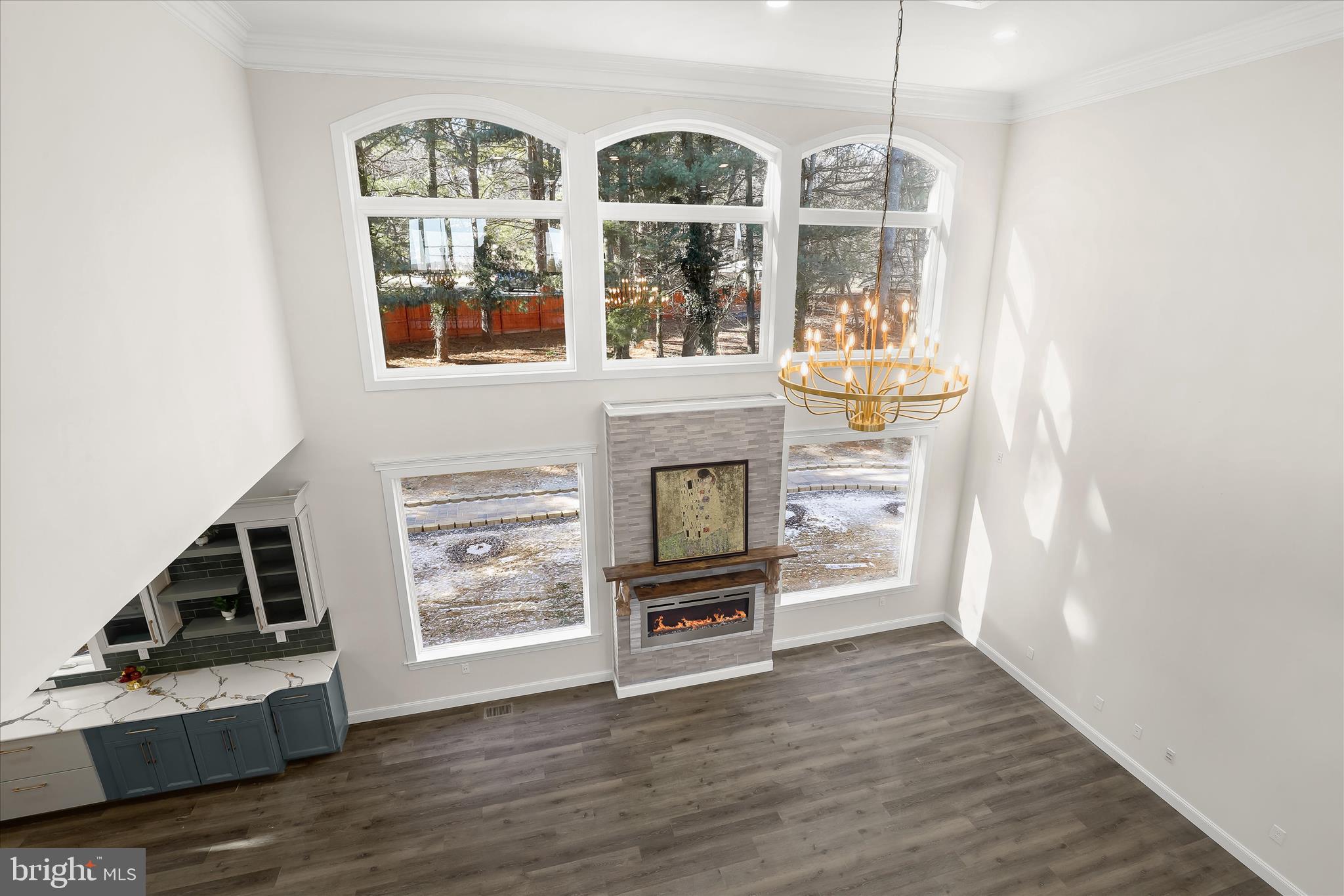 5004 Ten Oaks Road Dayton, MD 21036 - Photo 74 of 99 a view of an empty room with wooden floor fireplace and a window