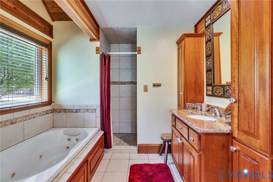 176 Baypointe Court Reedville, VA 22539 - Photo 36 of 60 a bathroom with a tub sink and mirror