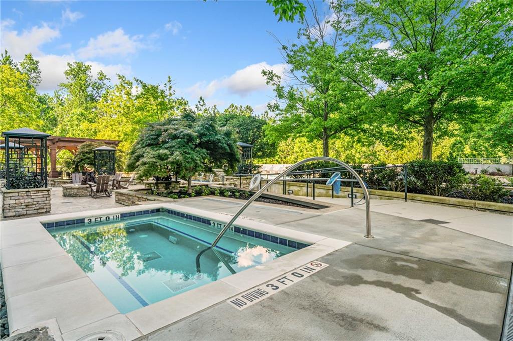 3300 Windy Ridge Parkway Southeast, Unit 1113 Atlanta, GA 30339 - Photo 27 of 39 a swimming pool with outdoor seating and garden