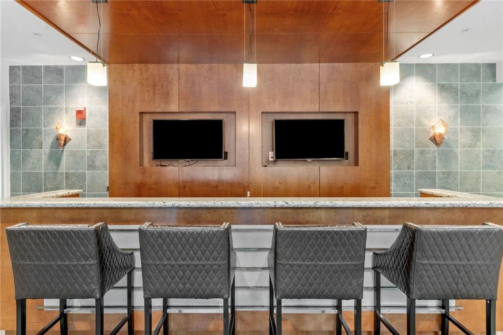 3300 Windy Ridge Parkway Southeast, Unit 1113 Atlanta, GA 30339 - Photo 30 of 39 a view of a dining room with furniture and wooden floor