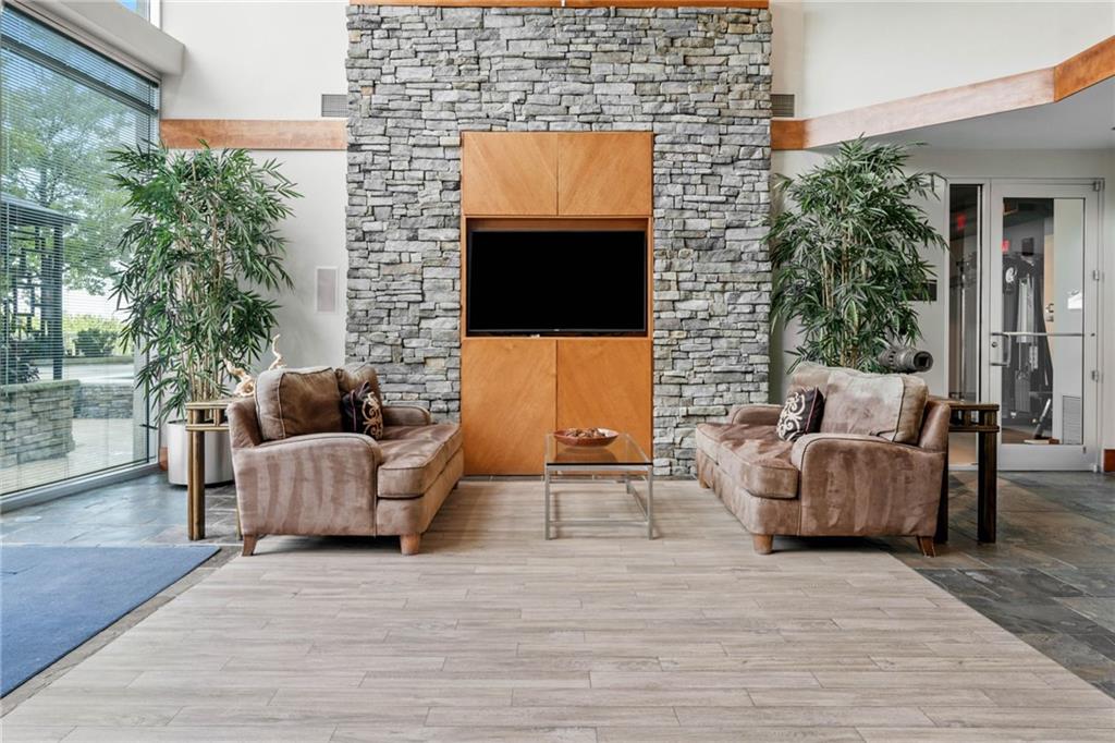 3300 Windy Ridge Parkway Southeast, Unit 1113 Atlanta, GA 30339 - Photo 31 of 39 a living room with furniture and a flat screen tv