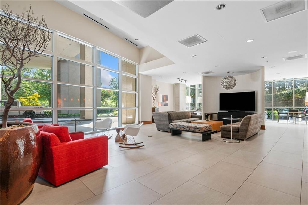 3300 Windy Ridge Parkway Southeast, Unit 1113 Atlanta, GA 30339 - Photo 36 of 39 a living room with furniture and a flat screen tv