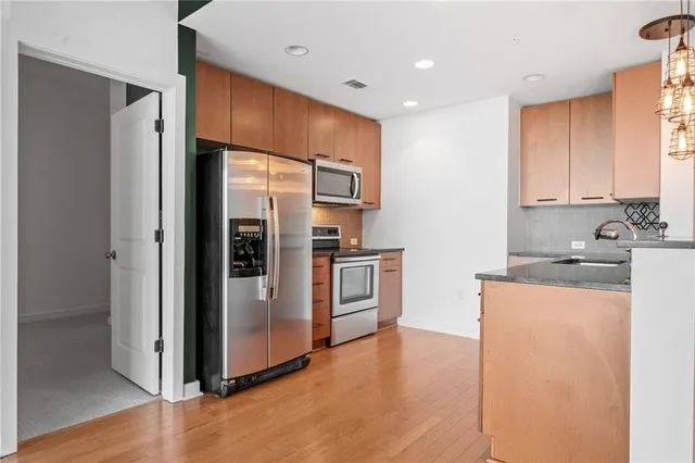 a kitchen with stainless steel appliances a refrigerator and a stove