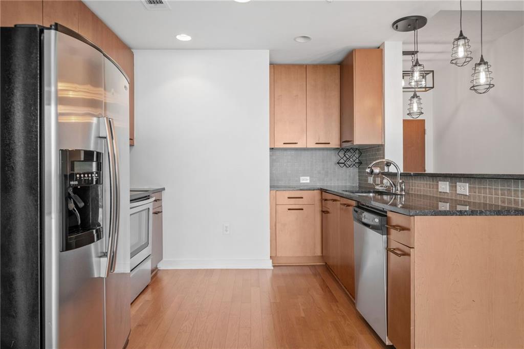3300 Windy Ridge Parkway Southeast, Unit 1113 Atlanta, GA 30339 - Photo 10 of 39 a kitchen with stainless steel appliances granite countertop a refrigerator and a sink