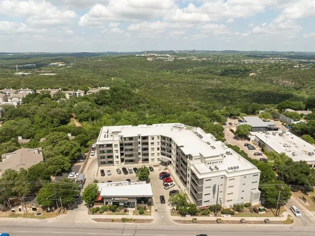 an aerial view of residential building and ocean