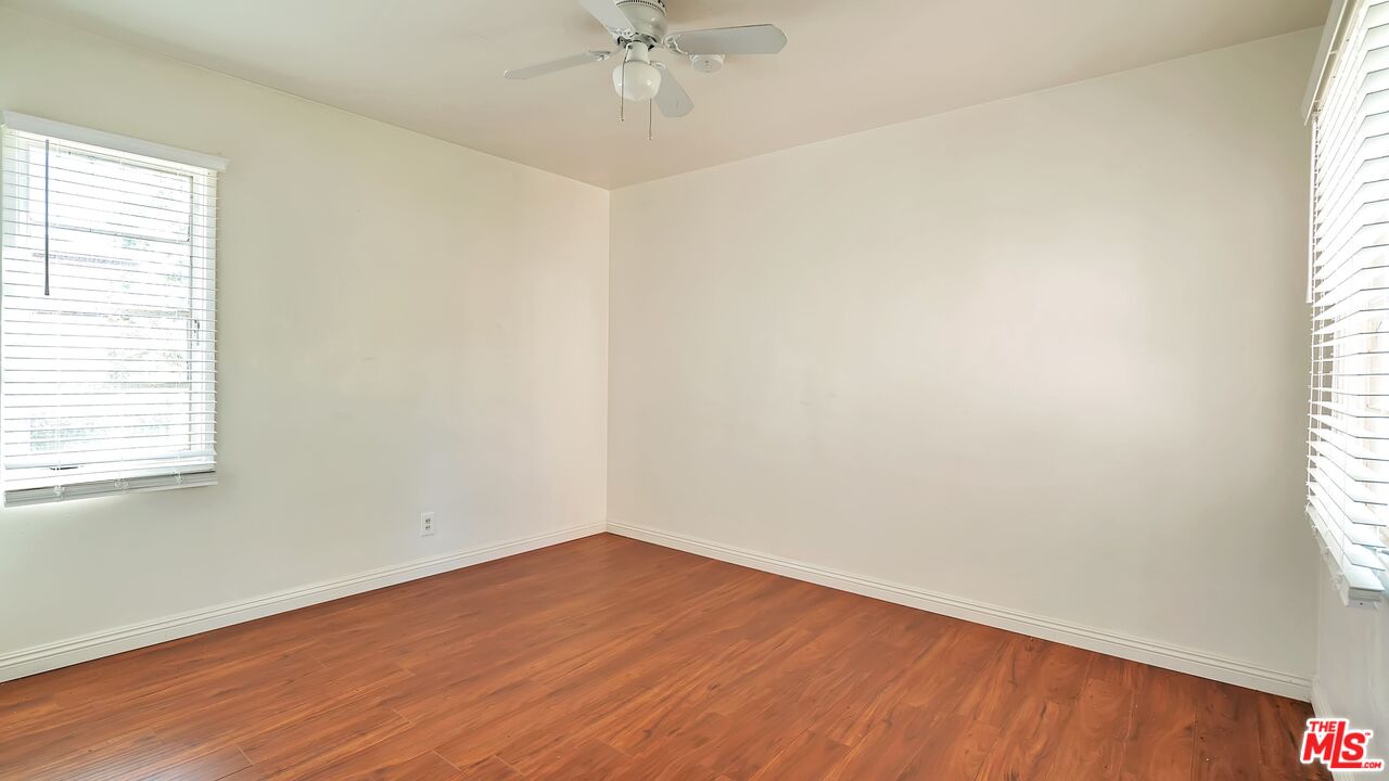 4063 Abourne Road, Unit B Los Angeles, CA 90008 - Photo 3 of 9 an empty room with a window and wooden floor