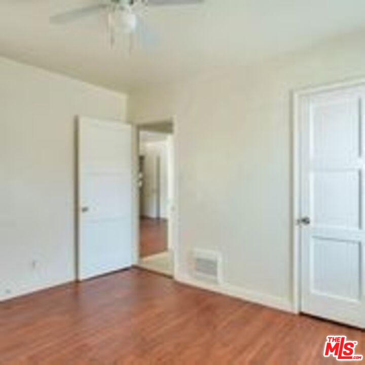 4063 Abourne Road, Unit B Los Angeles, CA 90008 - Photo 5 of 9 an empty room with wooden floor and closet area