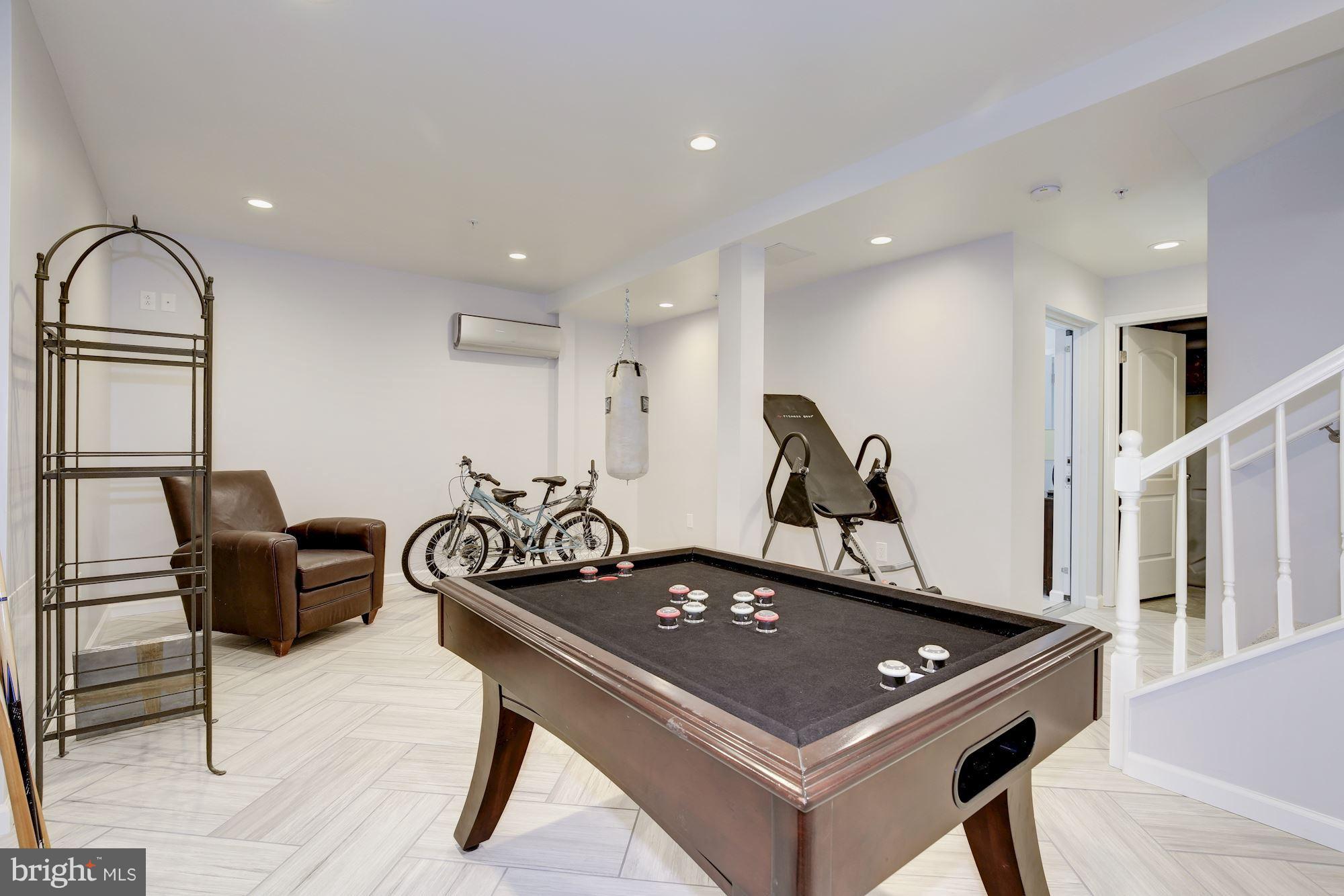4949 Allan Road Bethesda, MD 20816 - Photo 13 of 27 a room with gym equipment and windows