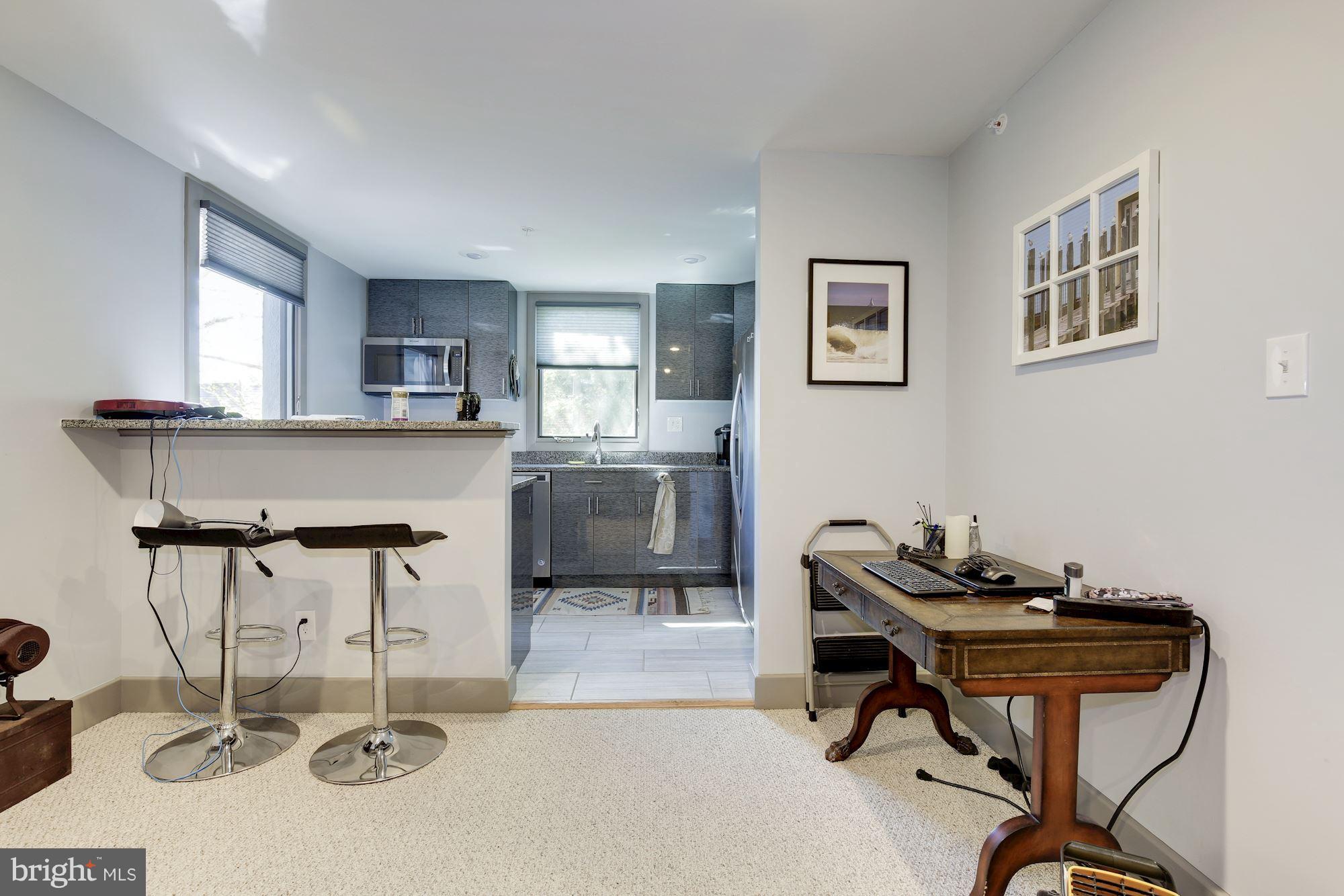 4949 Allan Road Bethesda, MD 20816 - Photo 16 of 27 a view of a workspace with furniture and a window