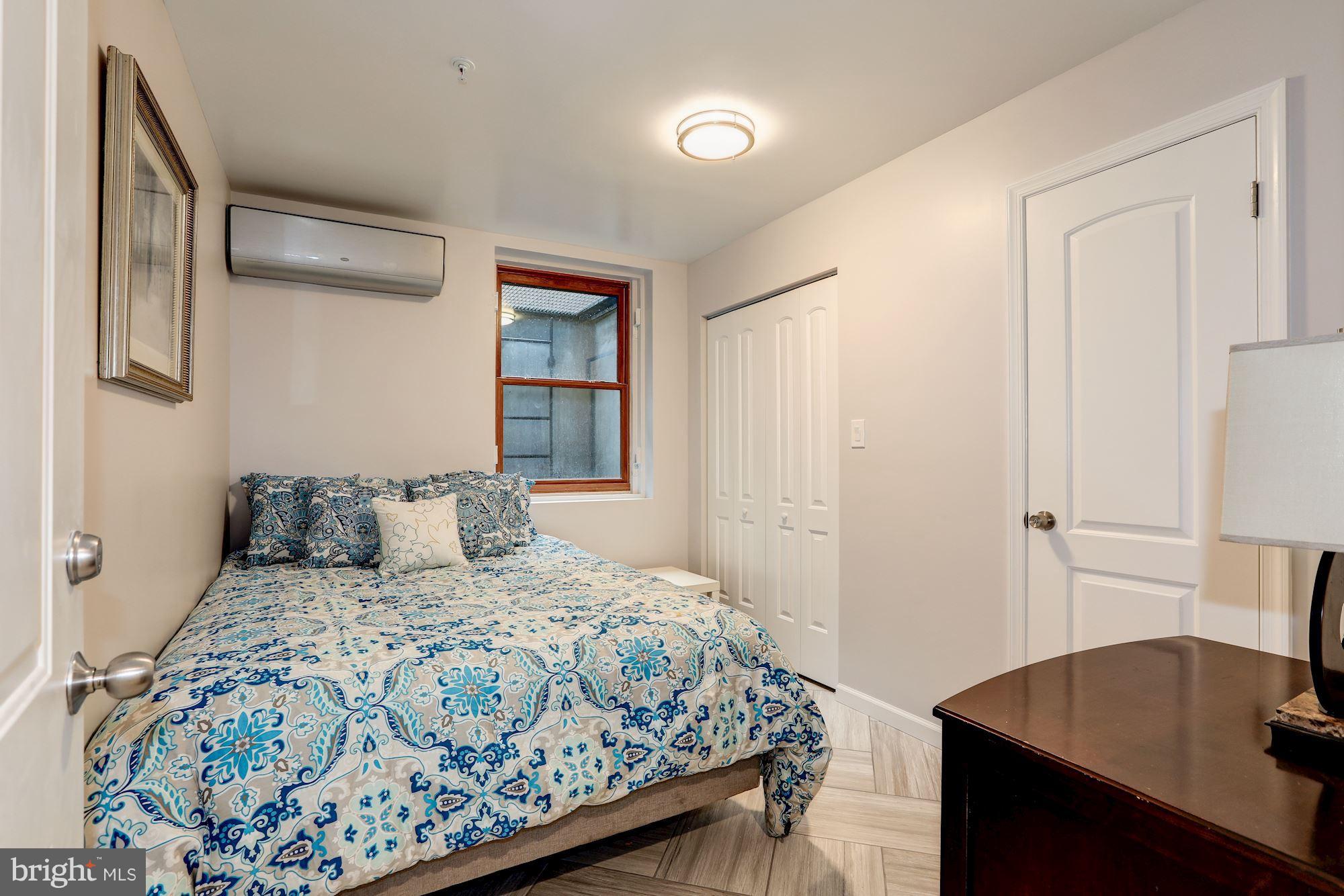 4949 Allan Road Bethesda, MD 20816 - Photo 19 of 27 a bedroom with a bed and a table in it