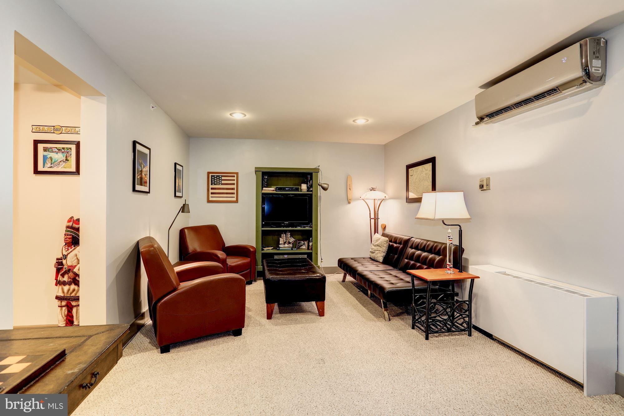 4949 Allan Road Bethesda, MD 20816 - Photo 25 of 27 a living room with furniture and a flat screen tv