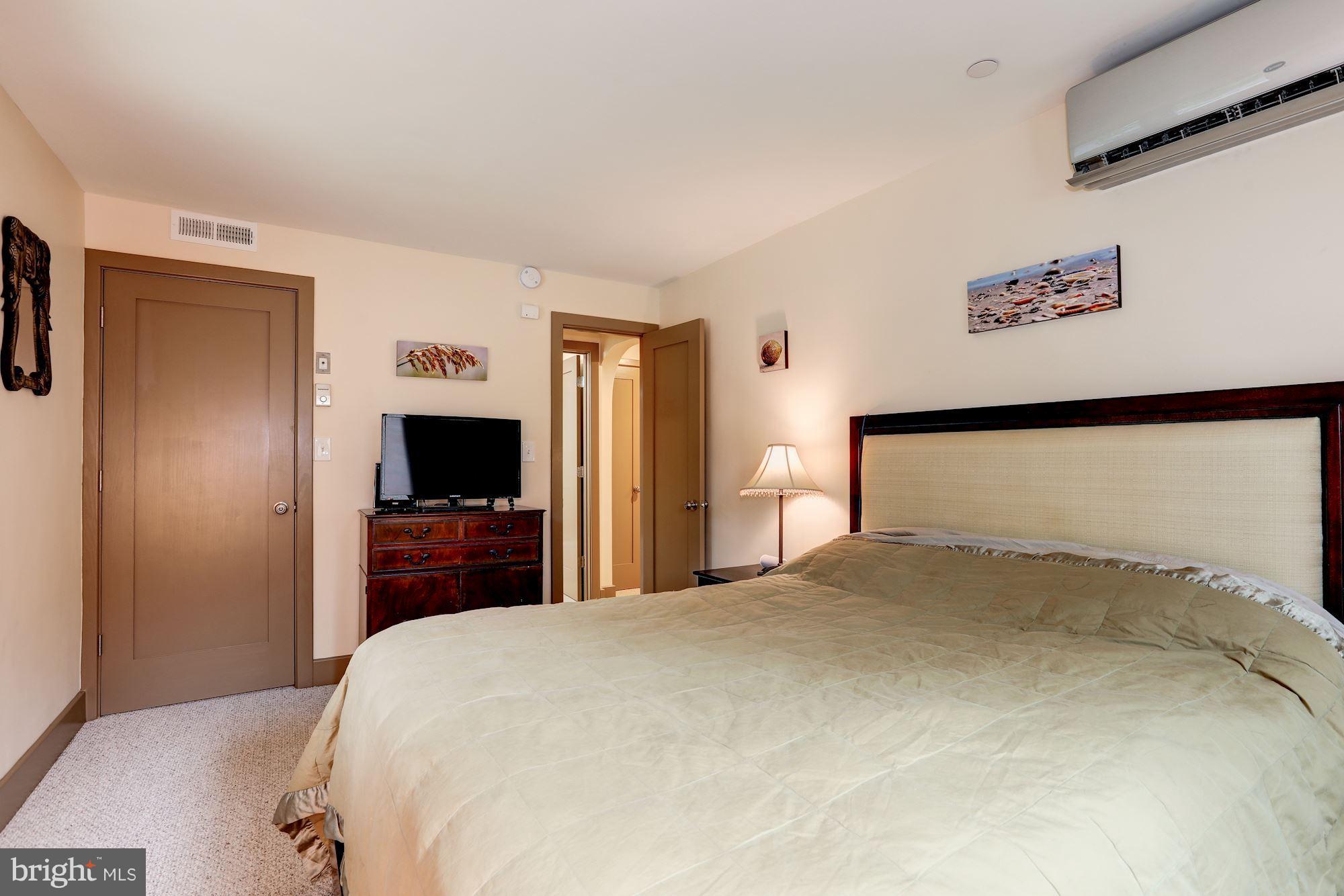 4949 Allan Road Bethesda, MD 20816 - Photo 26 of 27 a bedroom with a bed and a flat screen tv