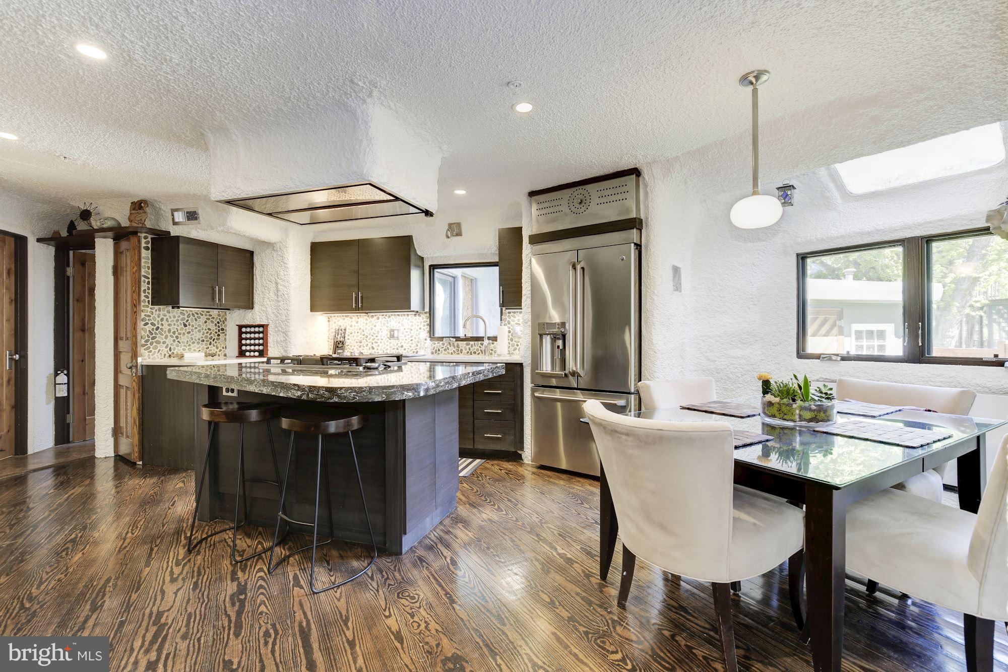 4949 Allan Road Bethesda, MD 20816 - Photo 5 of 27 a kitchen with kitchen island granite countertop a sink cabinets and stainless steel appliances