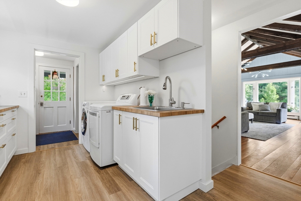 22 Stinson Road Andover, MA 01810 - Photo 22 of 40 a kitchen with a sink and wooden floor