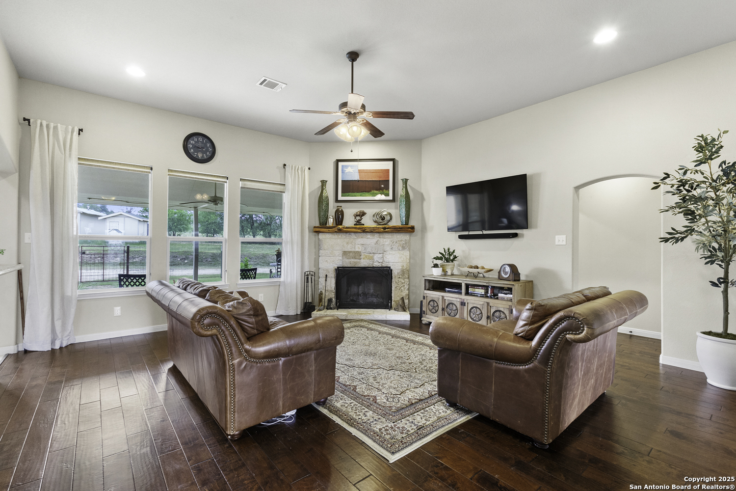 187 Tracks Center Point, TX 78010 - Photo 16 of 42 a living room with furniture a fireplace a flat screen tv and wooden floor