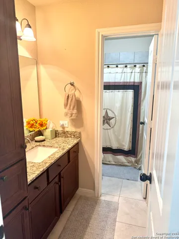 a view of a bathroom with a sink and mirror
