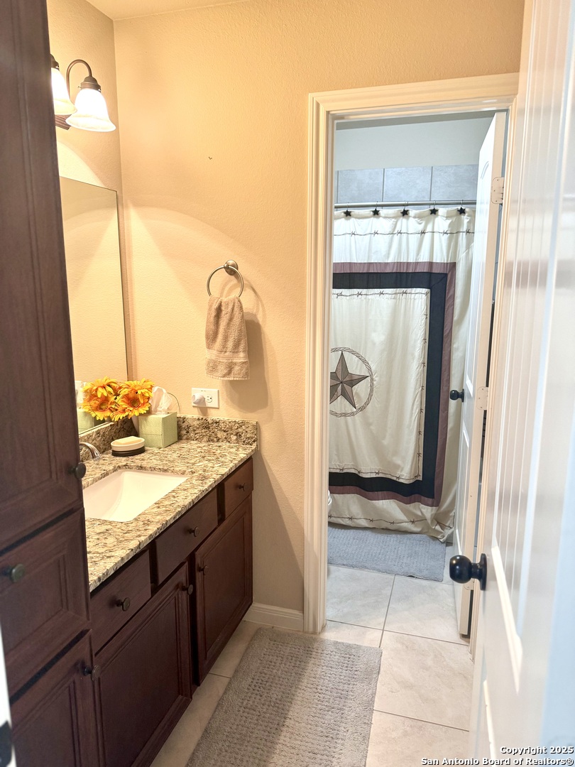 187 Tracks Center Point, TX 78010 - Photo 22 of 42 a view of a bathroom with a sink and mirror