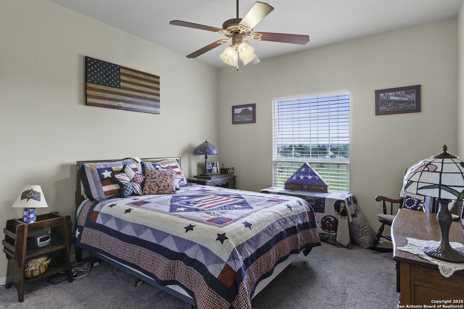 187 Tracks Center Point, TX 78010 - Photo 25 of 42 a bedroom with a bed and a chandelier