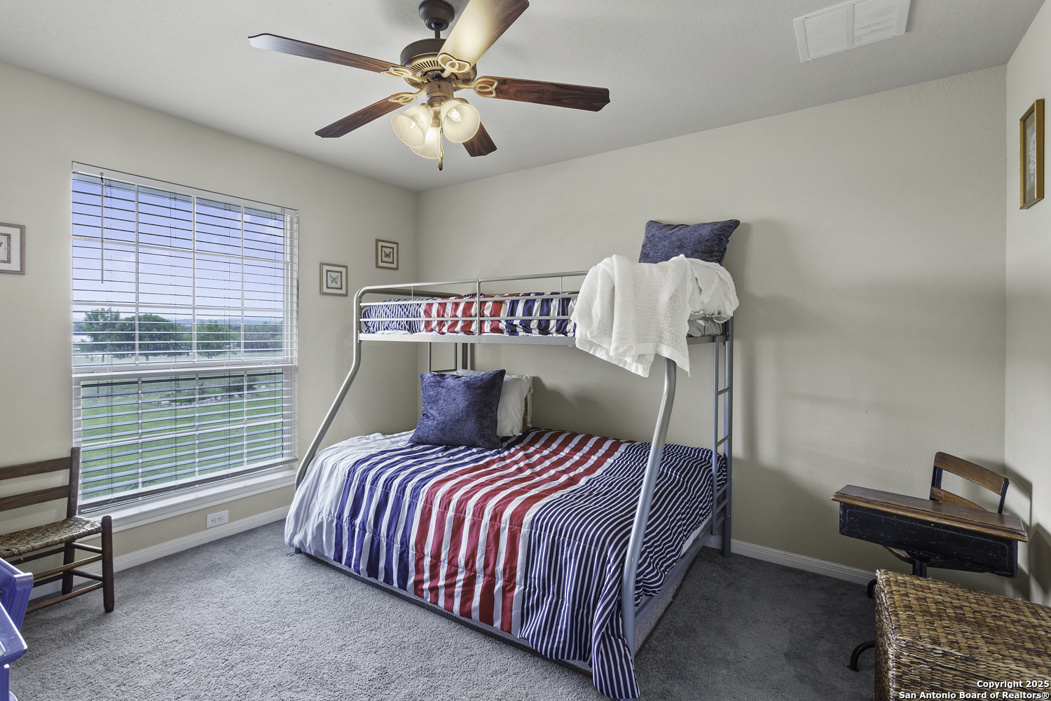 187 Tracks Center Point, TX 78010 - Photo 26 of 42 a bedroom with a bed and a chandelier fan