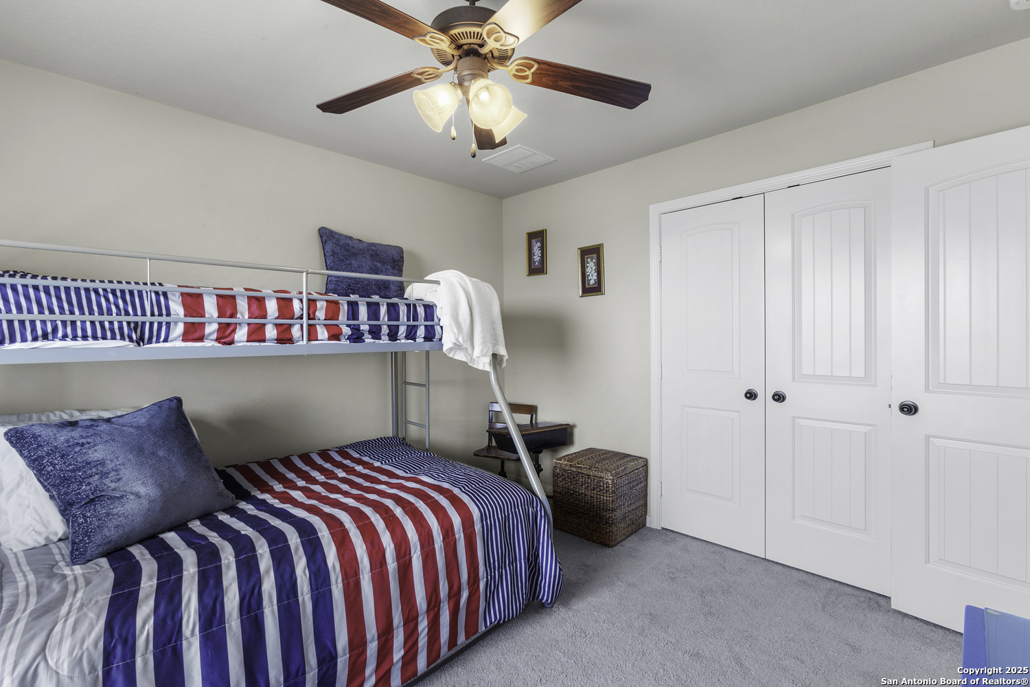187 Tracks Center Point, TX 78010 - Photo 27 of 42 a bedroom with a bed and a chandelier