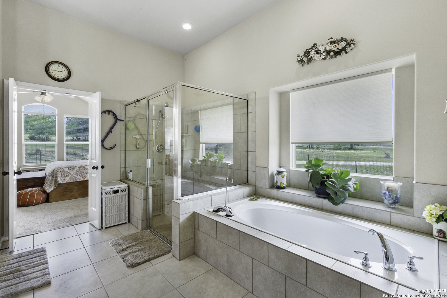 187 Tracks Center Point, TX 78010 - Photo 34 of 42 a bathroom with a tub a double vanity sink large mirror and a shower
