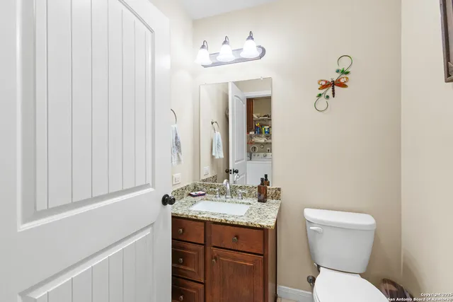 a bathroom with a toilet a sink and mirror